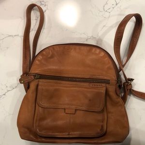 Leather backpack with top handle.